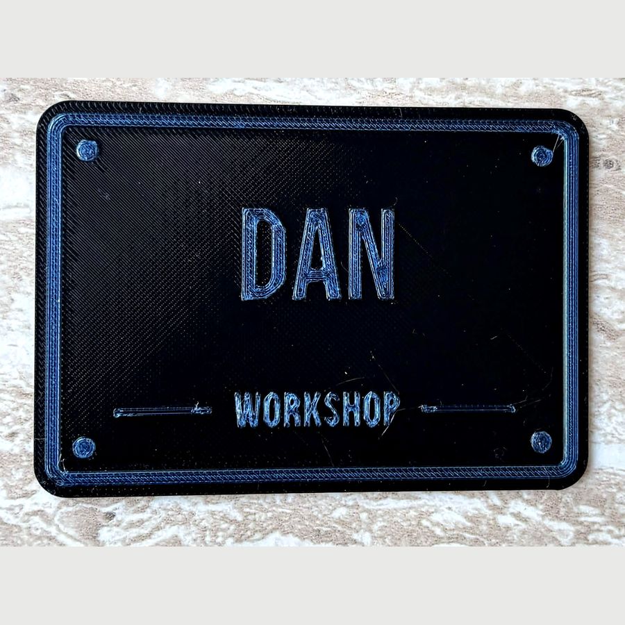 Black and blue personalised workshop plaque reading DAN WORKSHOP