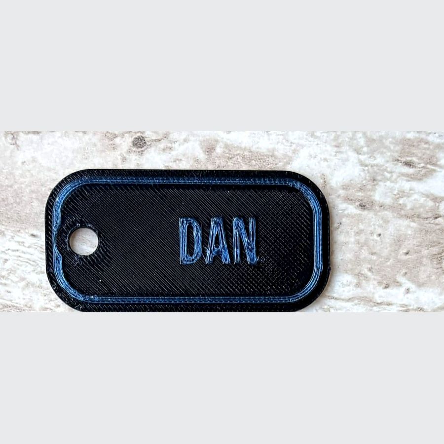 Black and blue personalised name keyring reading DAN